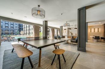 Outdoor covered lounge with kitchen, lounge area and gaming area